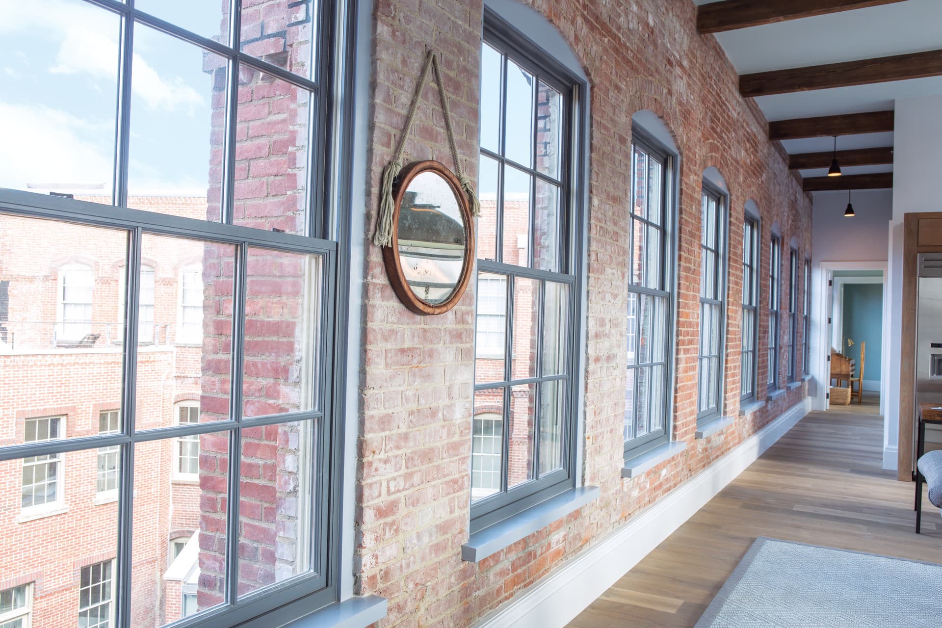 Andersen E-Series double-hung windows in an exposed brick interior