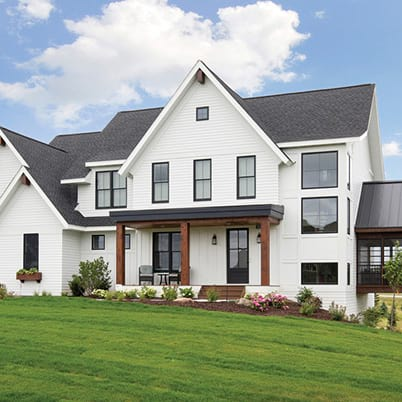 White home with black windows and warm wood accents